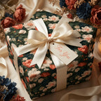 Vintage floral wrapping paper with a cream satin bow on a luxury gift box by Wrapped Studios.