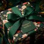 Luxury vintage floral wrapping paper tied with a dark green ribbon and Wrapped Studios tag.