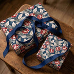 Luxury vintage floral wrapping paper with red roses and navy ribbon by Wrapped Studios.
