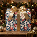Luxury navy and red floral holiday wrapping paper with a gold bow by Wrapped Studios.