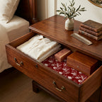 Wrapped Studios vintage red floral wrapping paper used as a drawer liner in a wooden dresser drawer.