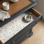 Vintage cream floral wrapping paper by Wrapped Studios lining an elegant dresser drawer.
