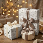Elegant grey floral wrapping paper on luxury gift boxes with satin bows by Wrapped Studios.