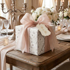 Elegant floral wedding wrapping paper with a dusty pink bow and gift tag, by Wrapped Studios.