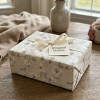 Vintage floral wrapping paper in neutral cream with a matching ribbon, luxury gift wrap by Wrapped Studios.