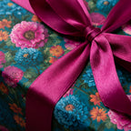 Teal floral wrapping paper with magenta satin ribbon, luxury birthday gift wrap by Wrapped Studios.