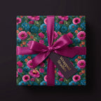 Luxury floral wrapping paper with pink and teal flowers and a magenta satin bow by Wrapped Studios.