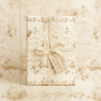 Elegant, vintage-style floral wrapping paper with lace ribbon on a rectangular gift box.