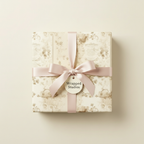 Elegant gift box wrapped in vintage floral wrapping paper with a blush pink satin ribbon and bow.
