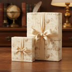 Elegant floral wrapping paper on gifts with gold ribbon bows for birthdays or special occasions.