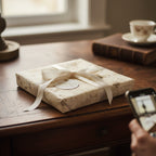 Elegant square gift wrapped in vintage floral wrapping paper with ivory ribbon.