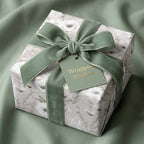 Luxury floral wrapping paper with a sage green velvet ribbon and Wrapped Studios gift tag.