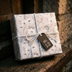 Grey and white vintage floral wrapping paper with rustic twine and tag by Wrapped Studios.
