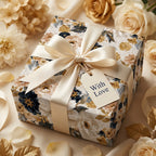 Luxury vintage floral wrapping paper with a cream satin bow and 'With Love' tag by Wrapped Studios.