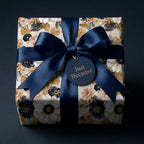 Luxury navy blue and gold floral wrapping paper with a satin ribbon bow by Wrapped Studios.