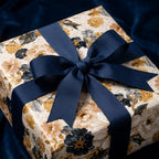 Luxury vintage floral wrapping paper in navy and gold with a navy ribbon bow by Wrapped Studios.