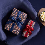 Vintage movie night wrapping paper with navy and red satin bows by Wrapped Studios.
