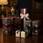 Moody dark floral wrapping paper and elegant luxury gift wrap with velvet bows by Wrapped Studios.