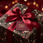 Dark floral wrapping paper on a luxury gift box with a burgundy satin bow by Wrapped Studios.