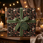 Dark floral wrapping paper with a sage green velvet bow and anniversary tag by Wrapped Studios.