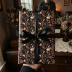 Luxury dark botanical floral wrapping paper with black satin bow by Wrapped Studios.