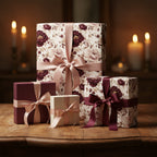 Elegant gifts wrapped in floral wrapping paper with burgundy and cream accents on a wooden table.