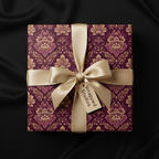 Elegant gift wrapped in purple floral wrapping paper with gold satin ribbon bow.