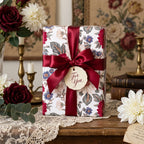 Luxury vintage floral wrapping paper with a burgundy satin ribbon and tag, by Wrapped Studios.