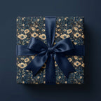 Navy blue floral wrapping paper on a square gift box with a matching satin ribbon bow.