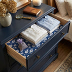 Navy floral wrapping paper used as a vintage dresser drawer liner by Wrapped Studios.