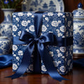 Elegant chinoiserie blue floral wrapping paper with a satin ribbon bow by Wrapped Studios.