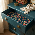 Vintage floral wrapping paper in red and teal lining a drawer. Luxury gift wrap by Wrapped Studios.