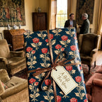 Luxury navy and red vintage floral wrapping paper with a gift tag and ribbon by Wrapped Studios.