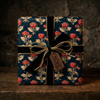 Luxury vintage Christmas gift wrap by Wrapped Studios with navy floral print, velvet ribbon, and Noel tag.