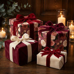 Vintage burgundy floral wrapping paper and luxury velvet ribbon on holiday gifts by Wrapped Studios.