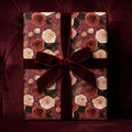 Luxury vintage floral wrapping paper with a burgundy velvet ribbon on a gift box by Wrapped Studios.
