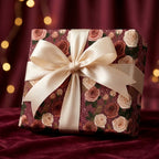 Vintage rose floral wrapping paper with cream satin bow on a luxury gift box by Wrapped Studios.