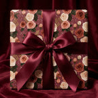 Elegant burgundy rose floral wrapping paper with a large satin bow by Wrapped Studios.