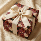 Luxury vintage floral wrapping paper in burgundy and cream with a gold-edged bow by Wrapped Studios.
