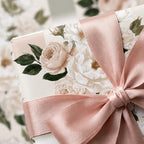 Luxury floral wrapping paper with vintage roses and a blush pink satin ribbon by Wrapped Studios.