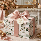 Elegant floral wrapping paper with a luxury blush pink satin bow by Wrapped Studios.