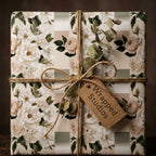 Vintage floral wrapping paper in sage green and cream with rustic twine bow by Wrapped Studios.