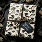 Fishing wrapping paper with trout pattern and leather bow by Wrapped Studios, rustic gift wrap for men.