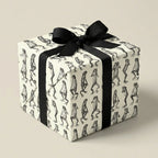 Unique gift wrap: Square gift box in frog print wrapping paper with a black grosgrain ribbon.