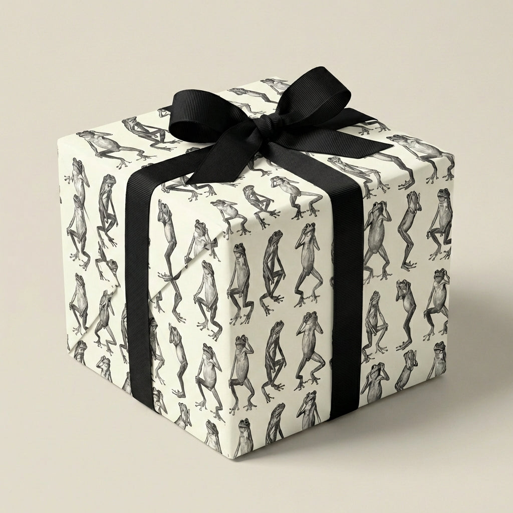 Unique gift wrap: Square gift box in frog print wrapping paper with a black grosgrain ribbon.