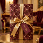Luxury burgundy and gold diamond pattern wrapping paper with a satin bow by Wrapped Studios.