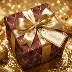 Burgundy and gold luxury gift wrap with geometric lines and a metallic gold bow by Wrapped Studios.