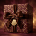 Luxury burgundy and gold holiday wrapping paper with a velvet bow by Wrapped Studios.