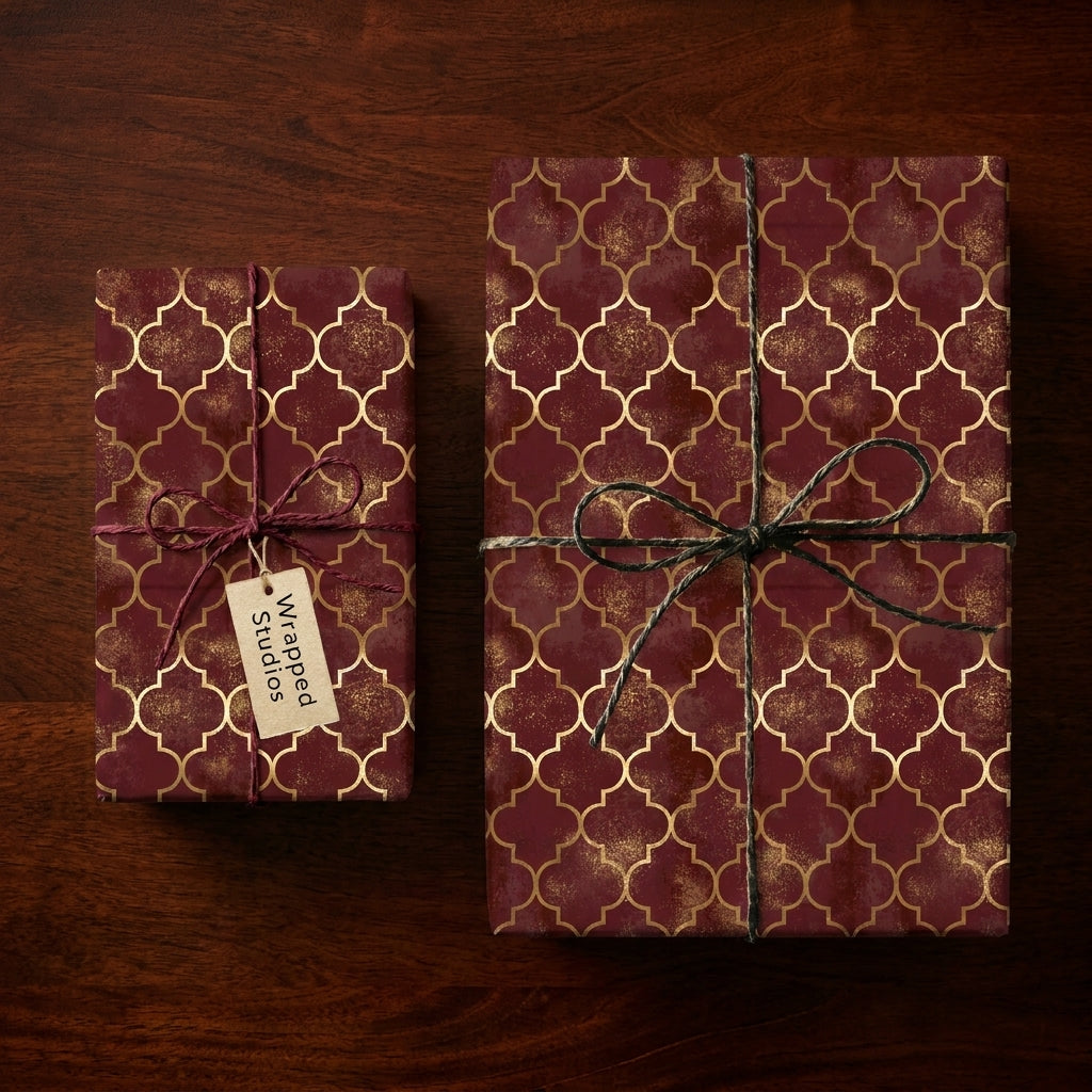 Luxury burgundy and gold wrapping paper with trellis pattern on gift boxes by Wrapped Studios.
