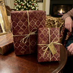 Luxury burgundy and gold Christmas wrapping paper with a trellis pattern by Wrapped Studios.